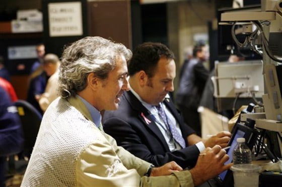 Traders work the trading floor of the New York Stock Exchange. Wall Street surged Friday after a relatively encouraging report on the jobs market lifted hopes about the pace of economic growth. 